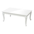 Table basse blanche en bois avec design élégant et détails sculptés.